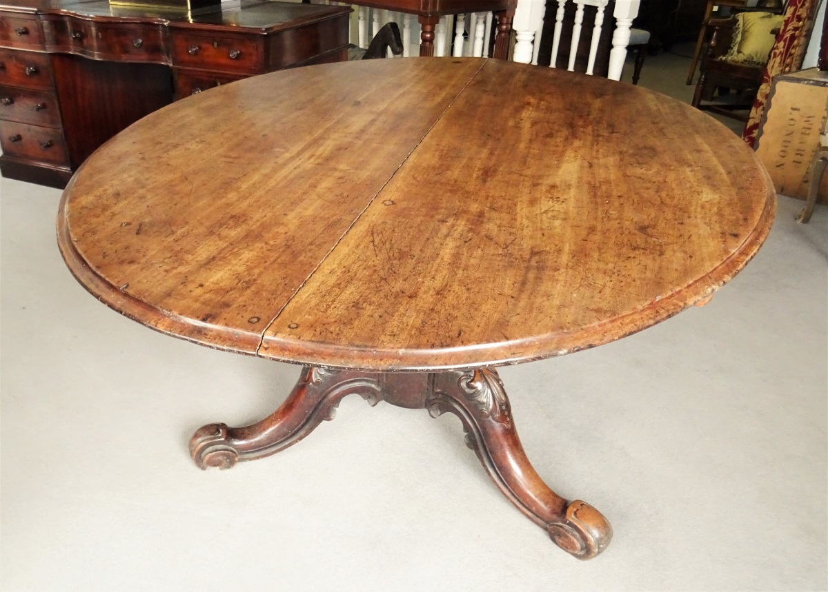 An Early Victorian Period Walnut Oval Pedestal Dining Table